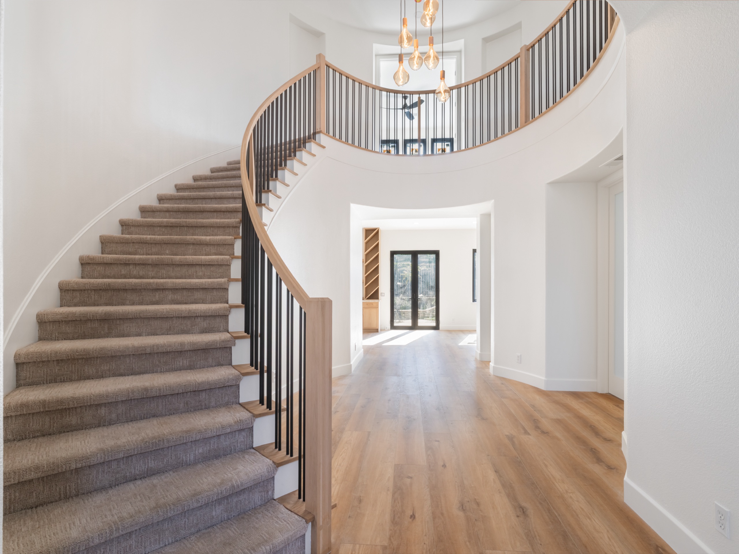 A sculptural curved staircase in a 5blox whole-home project, Fullerton
