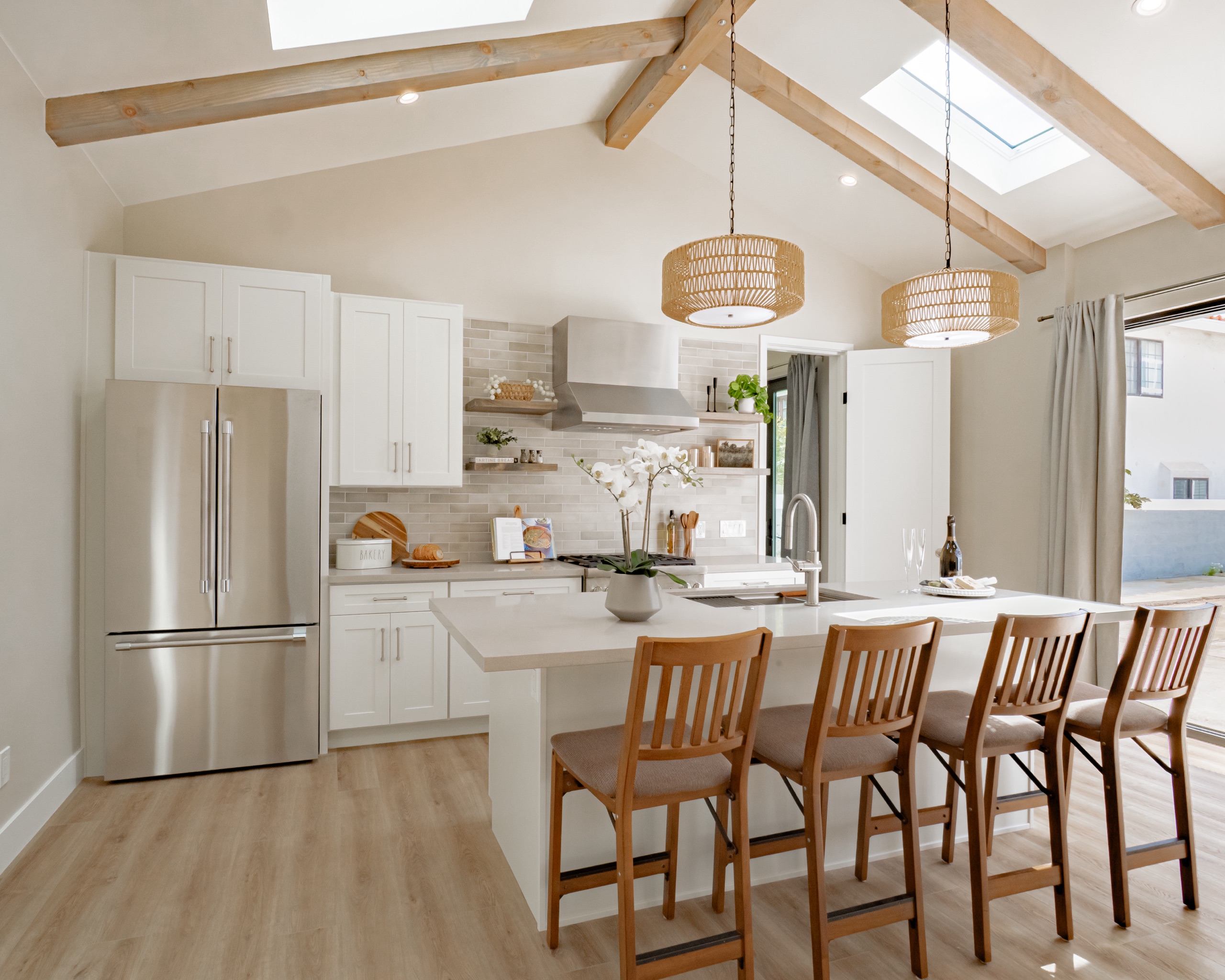 A styled kitchen with woven pendants and open shelving